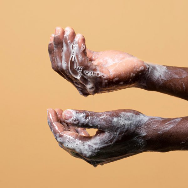 person-washing-hands-with-soap-isolated-orange